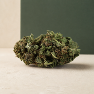 Deadfire OG AA flower long broadside macro showing dark sugar leaves