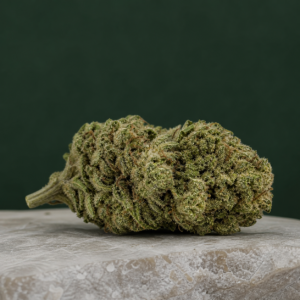 Dulce cannabis flower on a pale stone surface