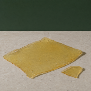 Good Giggles - Zkittles House Shatter 1g on a pale stone surface