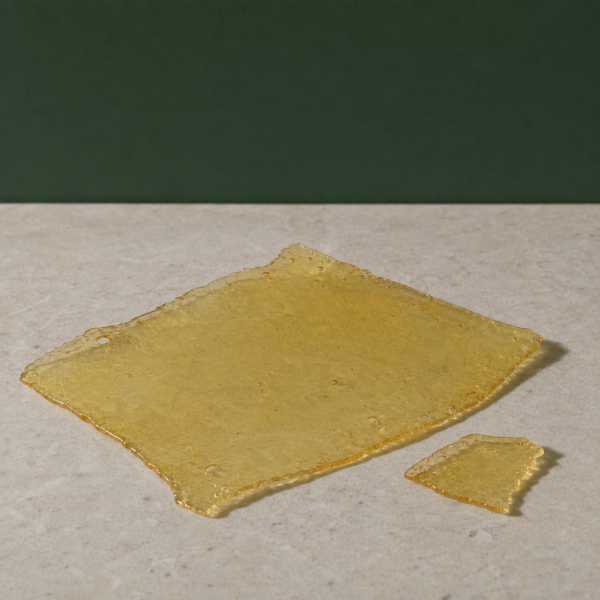 Good Giggles - Zkittles House Shatter 1g on a pale stone surface