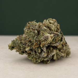 Kamikaze Kush AAAAA Reserve flower broadside macro with copper-rust pistils