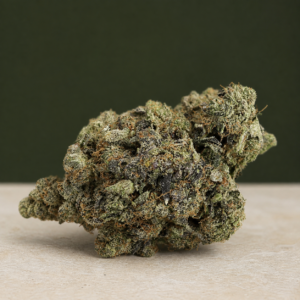 Kamikaze Kush AAAAA Reserve flower macro on pale stone