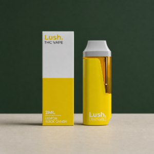 Lush Lemon Rock Candy yellow 2mL disposable vape beside its matching retail box
