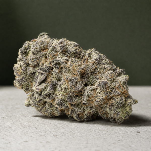 Pink Cloud cannabis flower on a pale stone surface