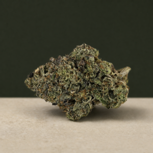 Psycho Kush AAAAA Reserve flower side-angle macro showing dark olive texture