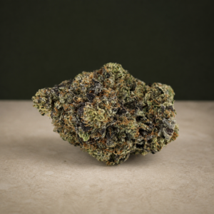 Psycho Kush AAAAA Reserve flower macro on a pale stone studio surface