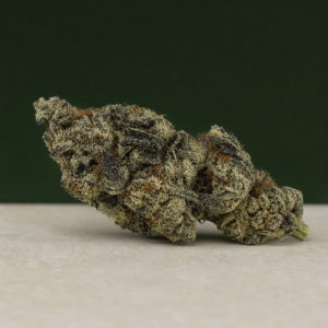Purple Fat Pie AAAA flower elongated side-angle macro on pale stone