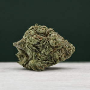 Sticky Poof cannabis flower on a pale stone surface