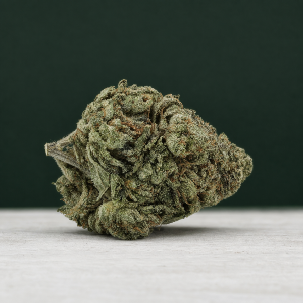 Sticky Poof cannabis flower on a pale stone surface